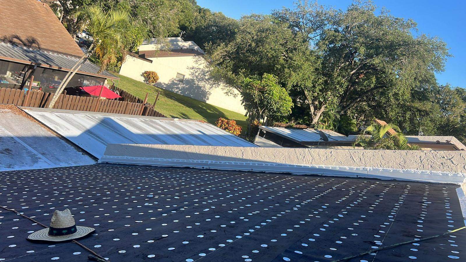 Palm Beach Gardens roof surrounded by neighboring homes and mature trees