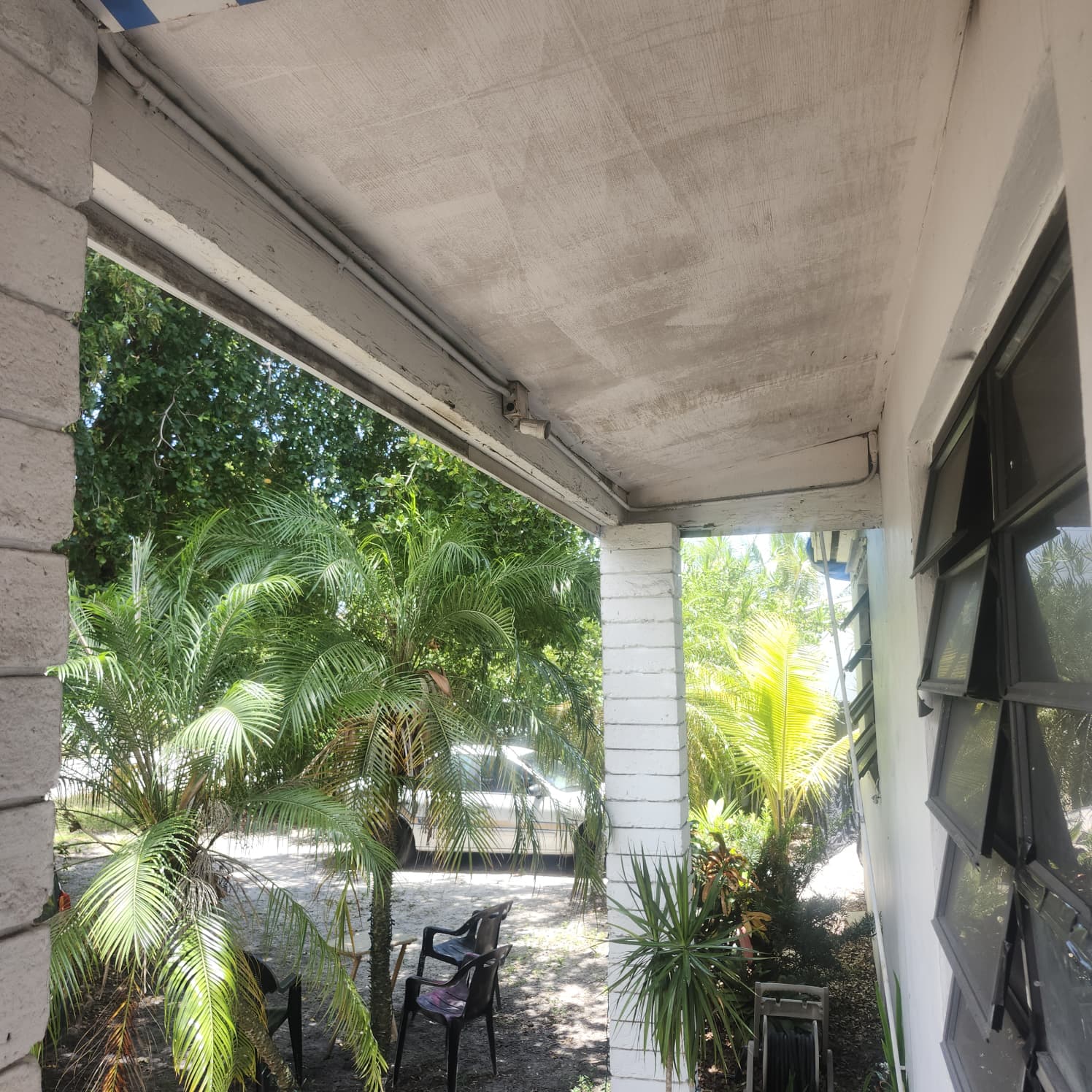 Covered porch soffit beside landscaping at a Palm Beach Gardens property